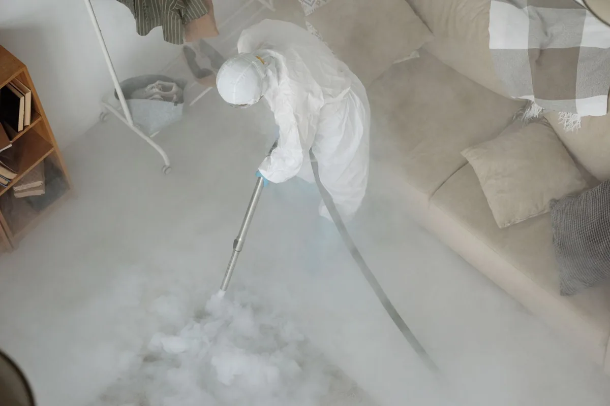 Biohazard cleanup technician in protective equipment, Corrigan, TX